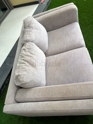 Light grey 2-seater fabric sofa in good condition, machine washable seat and cushion covers