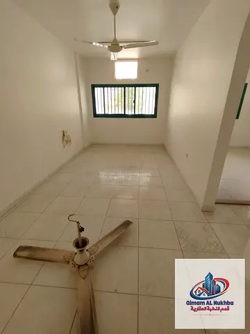 1BR in Al Nabba on the main road, close to services, no AC, central gas, full maintenance after contract. AED 20K yearly, 4 or 6 payments.