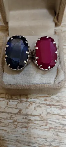 Pair of oval blue and red gemstone body rings in silver setting