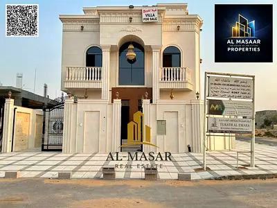 Two-story villa with a roof terrace in Al Helio 1, Ajman; features 7 master bedrooms; freehold ownership available to all nationalities.