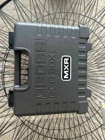 Selling a guitar effects pedal set in a sturdy Boss protective carrying case.