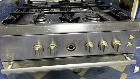 Used 4-Burner Stainless Steel Gas Stove with Oven - working goof