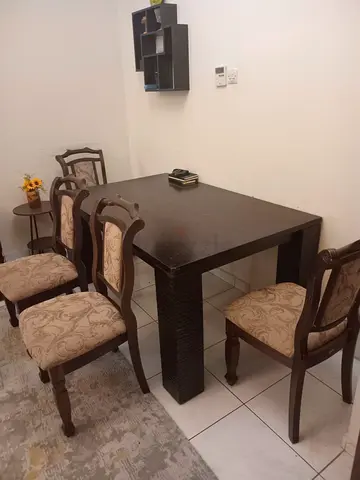 Solid wood dining table with 4 matching chairs - good condition