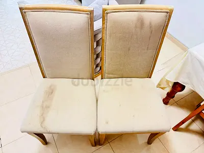 Pair of beige upholstered dining chairs with wooden legs - used