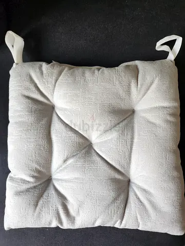 Plain light gray tufted chair seat cushion with ties