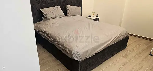 King-size upholstered bed frame with tufted headboard - dark grey