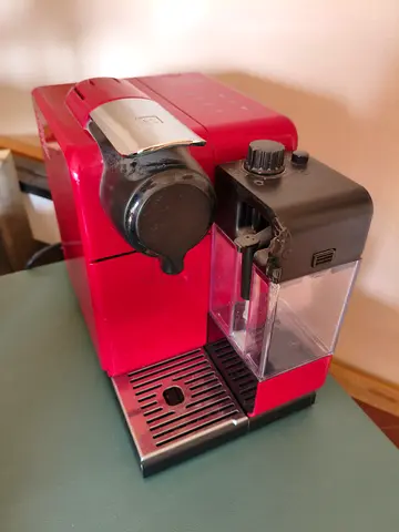 Red capsule nespresso machine with milk frother - used