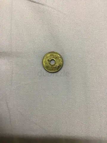 This is a 5 Japanese Yen (5 JPY) coin, featuring its signature center hole, rice ear, and gear desig