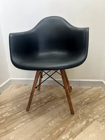 Modern black Eames Style Armchair with Wooden Legs. 70 dhs each (6 chairs available)