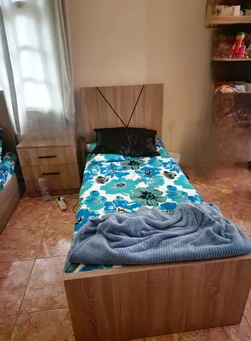 2 Single wooden bed with headboard and bedside drawer - good condition