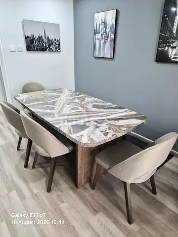 Modern marble-top dining table with 5 upholstered chairs