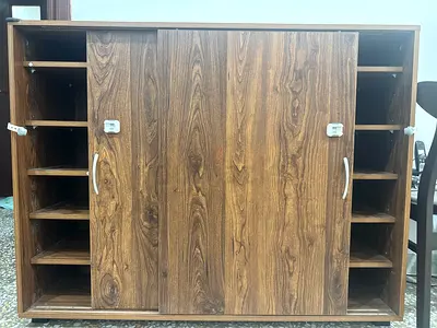 Low wooden storage cabinet with sliding doors