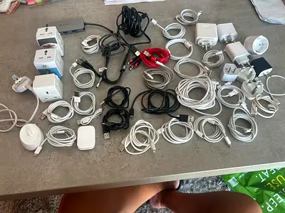 Mixed lot of phone chargers, cables, adapters and travel plugs — used