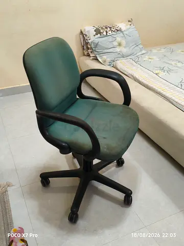 Green office swivel chair with armrests