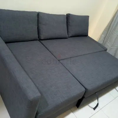 Grey fabric L-shaped sofa bed with storage