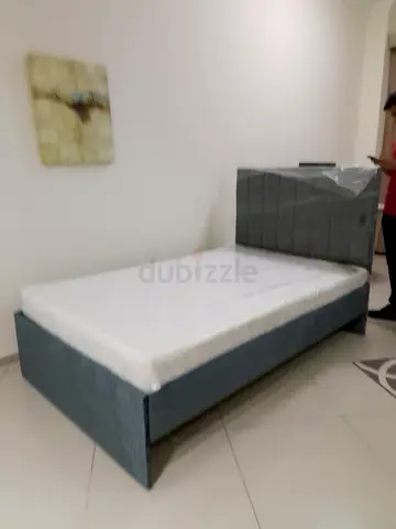 Single bed frame with upholstered headboard and mattress -