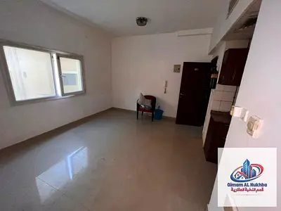 Affordable annual studio for rent in Al Nabba, Sharjah for AED 17,000, featuring a fitted kitchen, built-in cabinets, practical layout