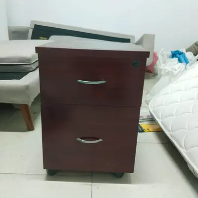 Used two-drawer mobile office pedestal cabinet - dark wood finish with wheels
