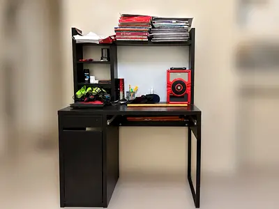 Compact dark wood study desk with shelving and cabinet