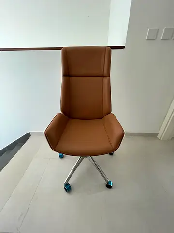 Brown leather swivel office chair with chrome base
