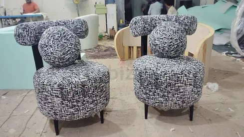 Pair of modern patterned accent chairs with rounded backs