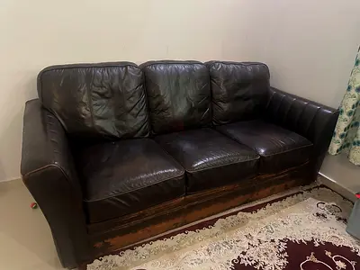 Three-seater dark brown leather sofa — used, sturdy frame