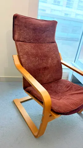 Comfortable brown lounge chair with wooden frame