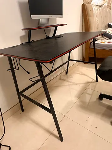 Black ergonomic gaming/office chair with adjustable armrests and headrest
