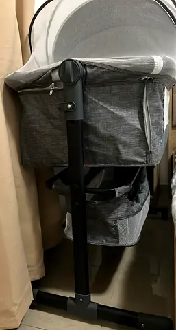 Grey bedside bassinet with storage and canopy - good condition