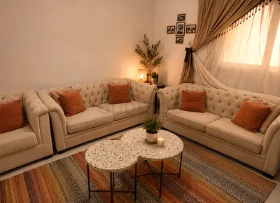 cream-colored tufted Chesterfield sofa set with matching curtains