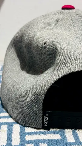 Grey Vans snapback cap with pink top button, adjustable