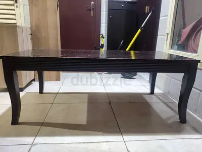 Used dark wood coffee table with curved legs