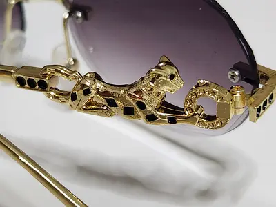Rimless round sunglasses with gold-tone bridge and purple lenses