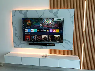 50-55 inch Smart LED TV mounted with soundbar and cabinet