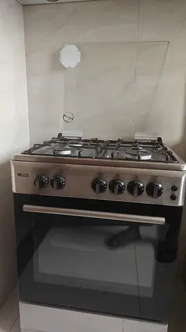 Used stainless steel gas oven with 4 burners and built-in grill