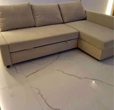 Light beige L-shaped sofa bed with storage and pull-out bed, good condition