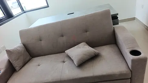 2-seater grey fabric sofa with cup holder – good condition