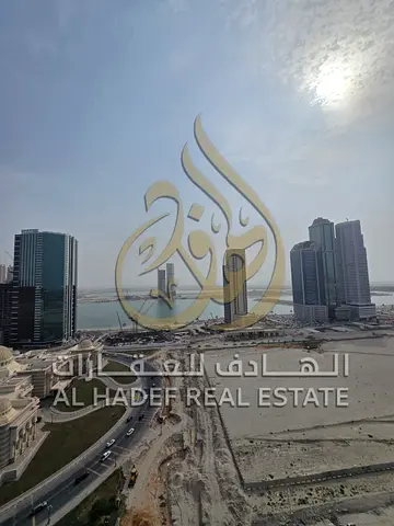 3-bedroom apartment with a living room in the Al Khan area, Sharjah. Features an unobstructed sea view, master bedrooms, a balcony, and parking. Inclu