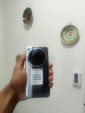 Xiaomi 15 Ultra Black and Silver Smartphone with a charger.