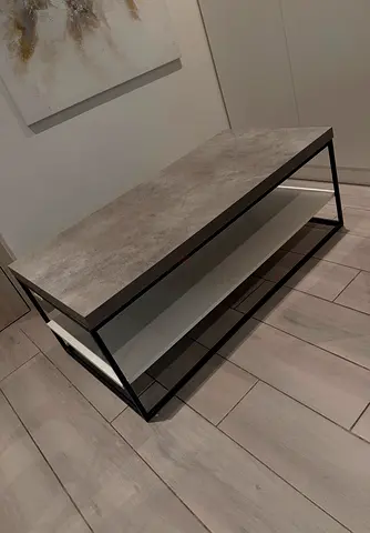 Modern concrete-look coffee table with black metal frame