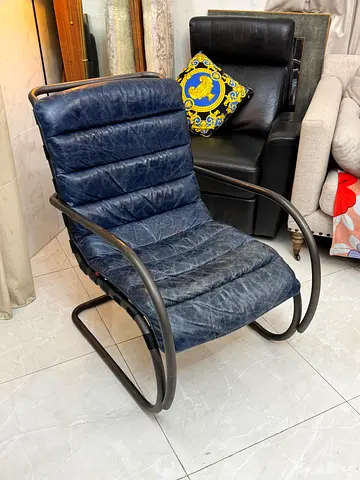 Navy Blue genuine leather rocking chair with a bent metal frame