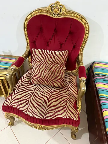 Vintage-style carved wood armchair with red velvet upholstery
