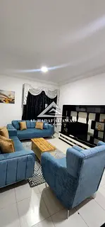 A furnished two-bedroom apartment with a living room for monthly rent in Al Qassimiya.