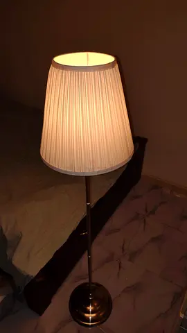 Tall floor lamp with white pleated shade, adjustable metal stand
