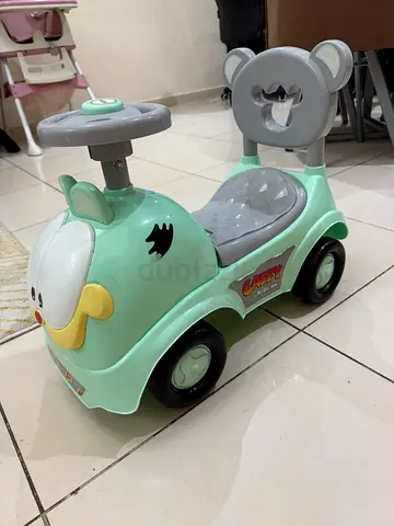 Mint green ride-on walker car for toddler with steering wheel