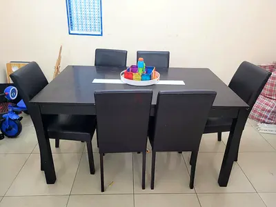 6-seater dark brown wooden dining table with chairs