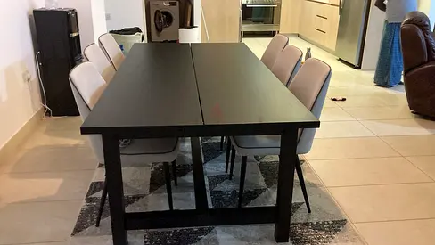 Solid black extendable dining table with 6 chairs Table from Ikea, chairs from Home centre