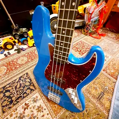 Blue 4-String Electric Bass Guitar - Maple Neck. New. Never Used. AED 550 Only.