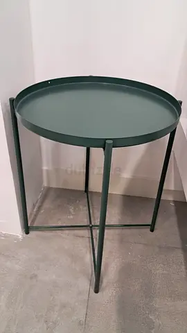 Small round green metal side table