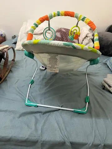 Lightly used baby jumper/exerciser with toy bar - good condition